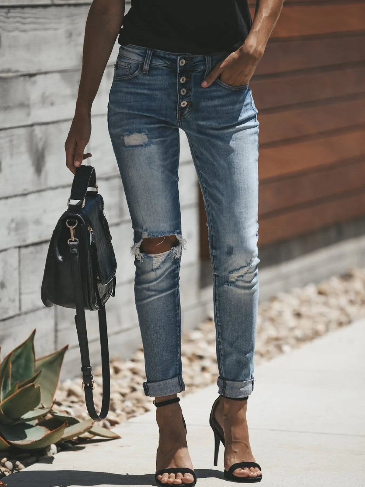 Light blue skinny jeans showing button fly detail