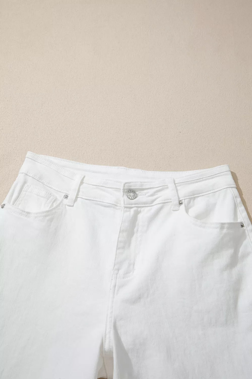 White loose jeans seated view