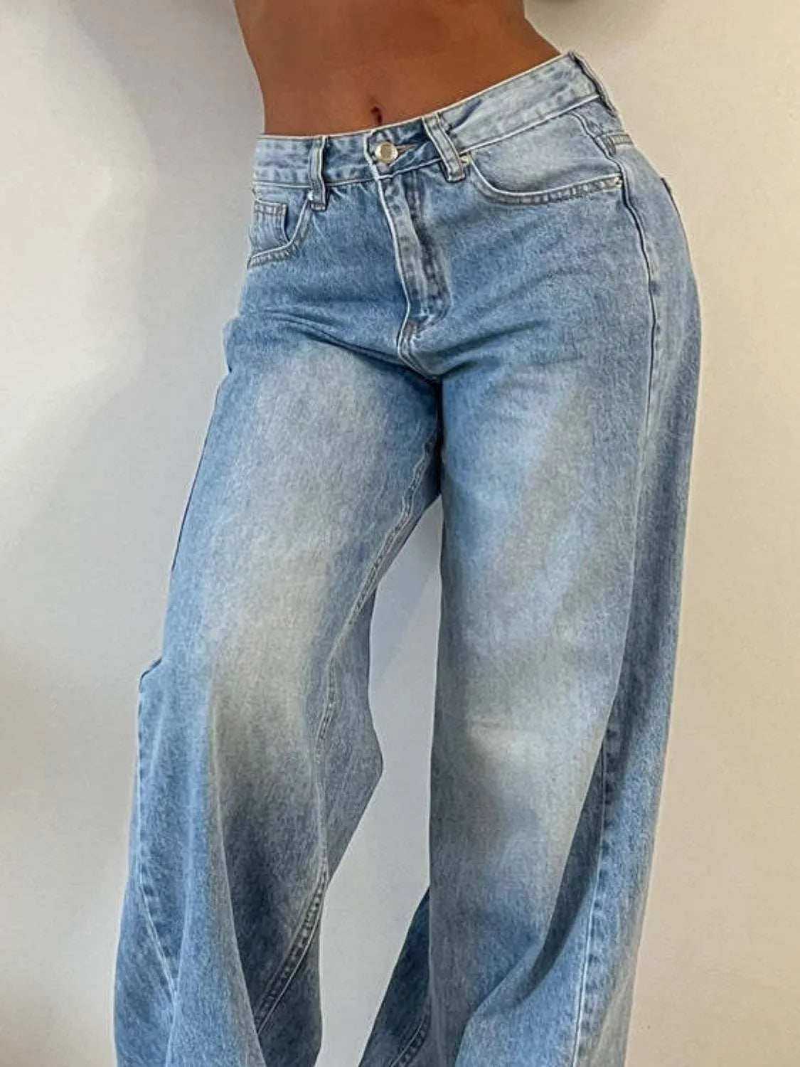 Model wearing wide leg jeans with pockets