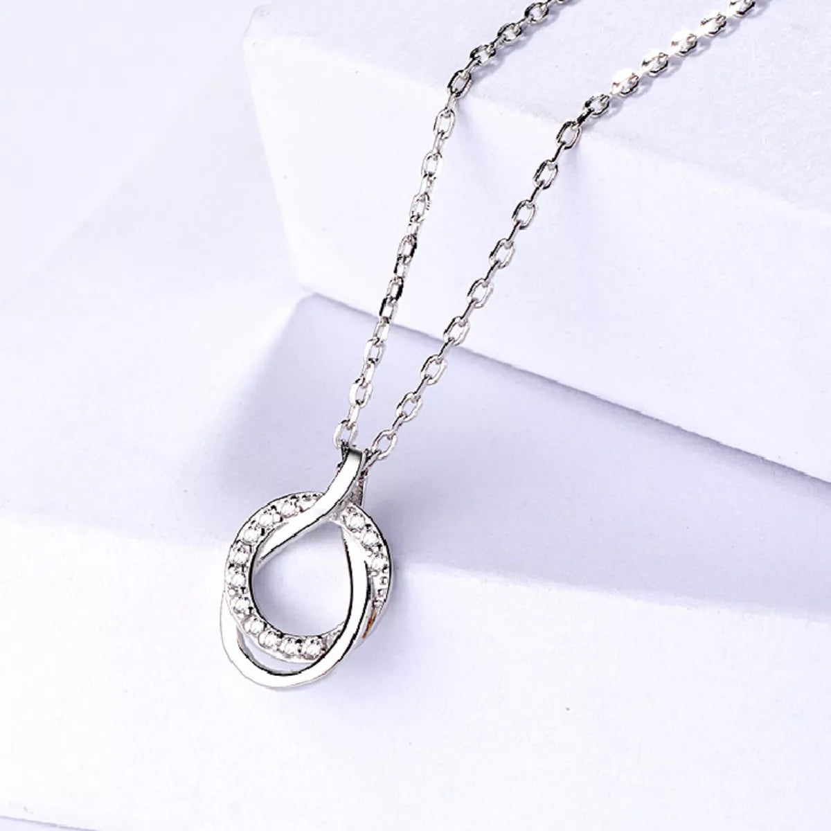 Sterling silver zircon pendant necklace worn on a model