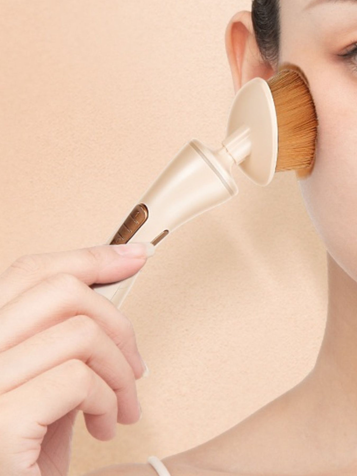 Electric makeup brush held in hand