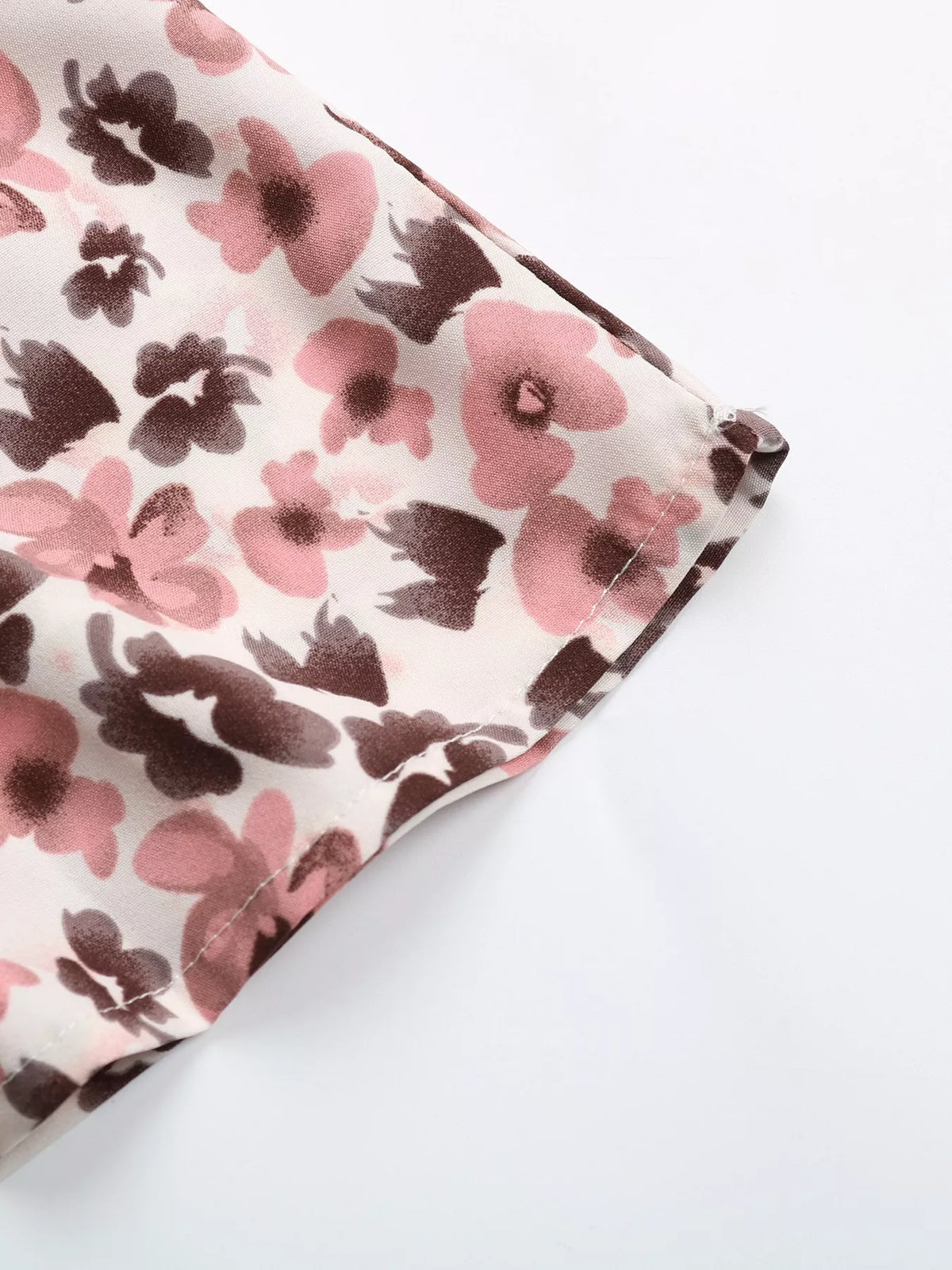 Pink floral tie neck ruffle blouse close up view