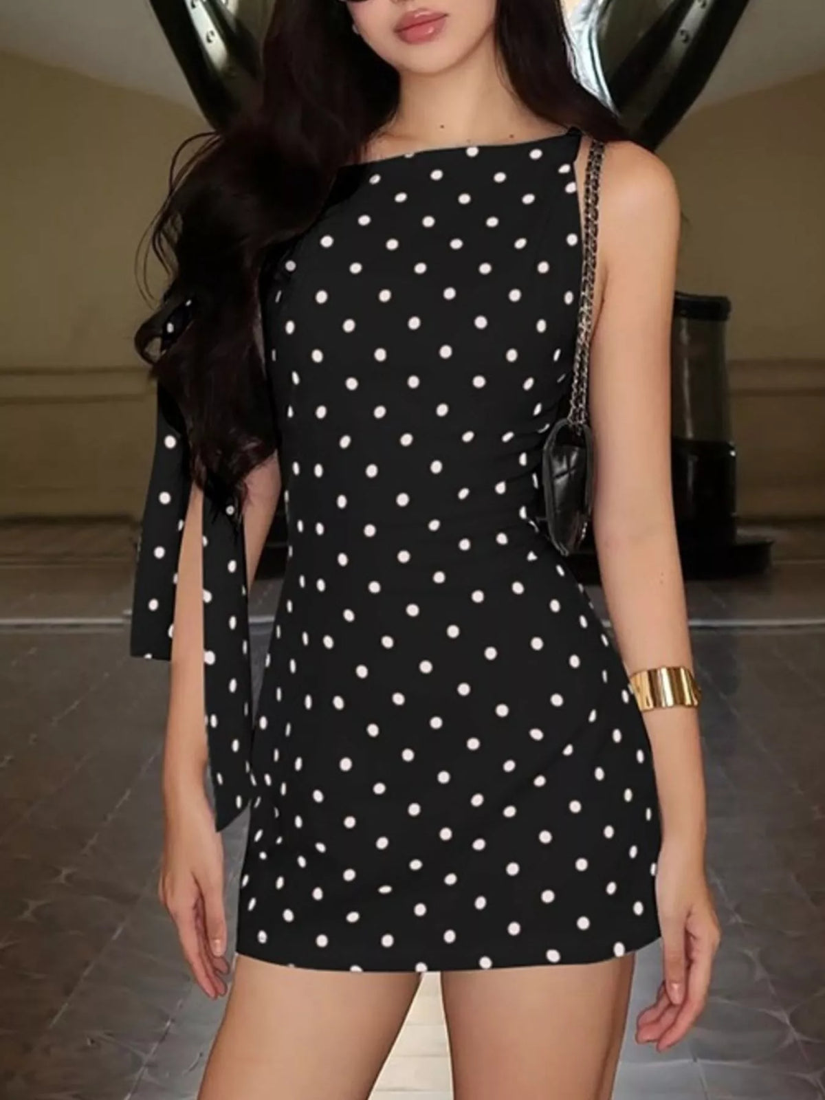 Bow accents on the red polka dot sleeveless dress
