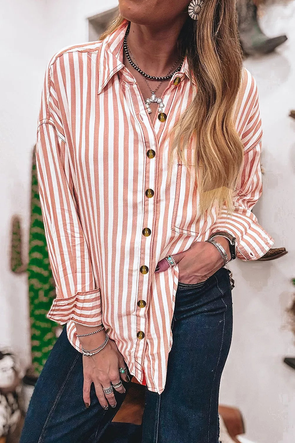 Striped western shirt worn open over a tank top