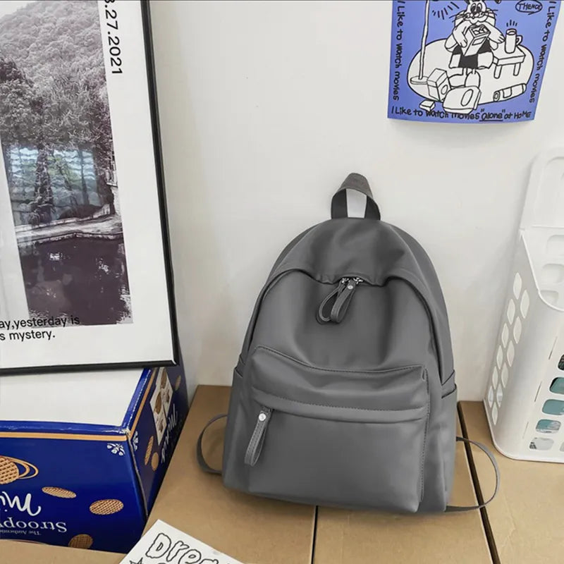 Faux leather zip backpack held in hand
