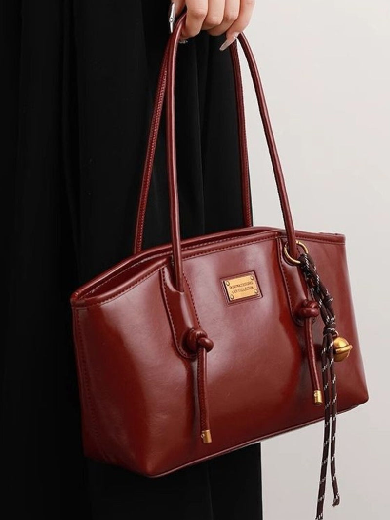 Burgundy leather shoulder bag with knot detail front view