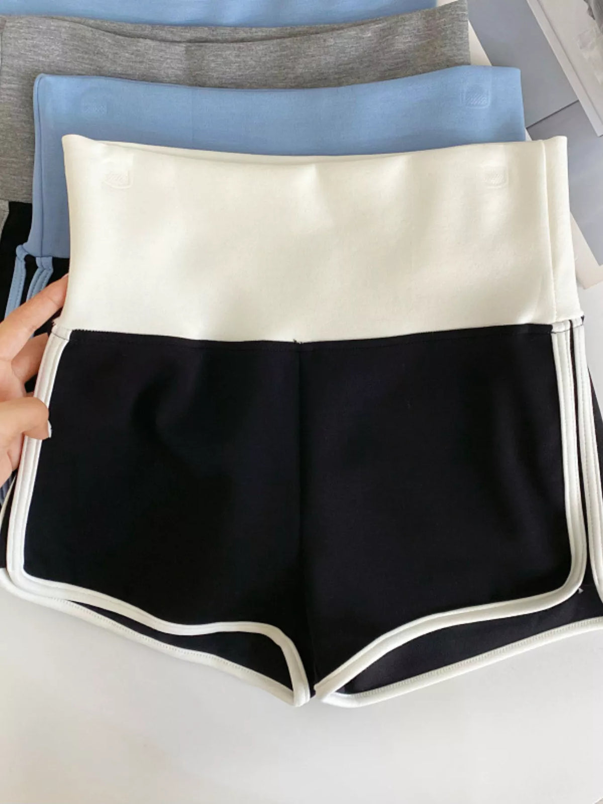 High waist contrast trim shorts, angled view