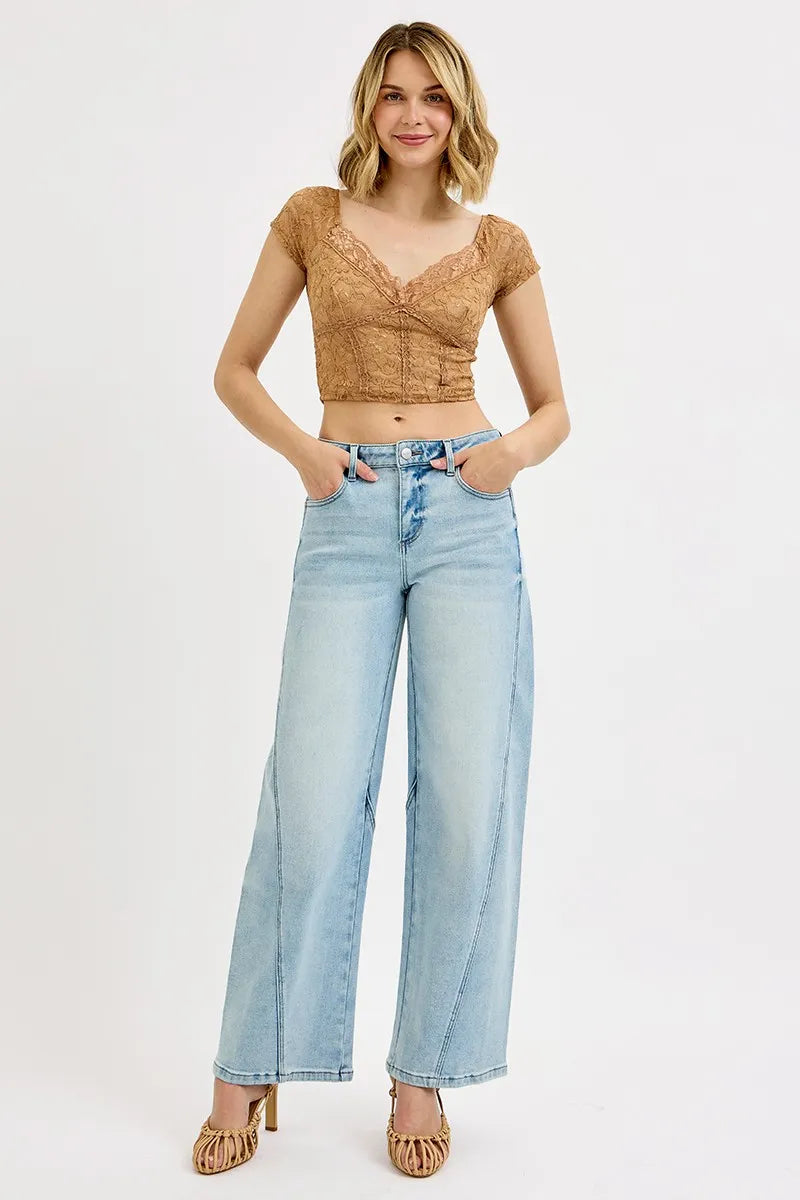 Model wearing light wash barrel jeans