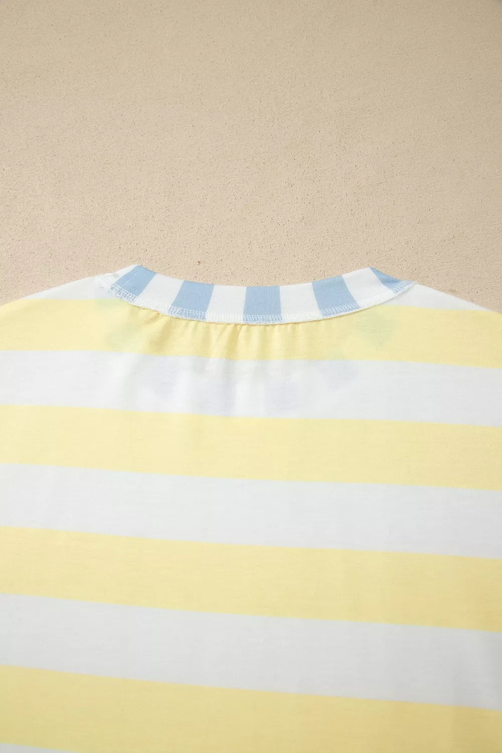 Stripe pattern close up on the light yellow top