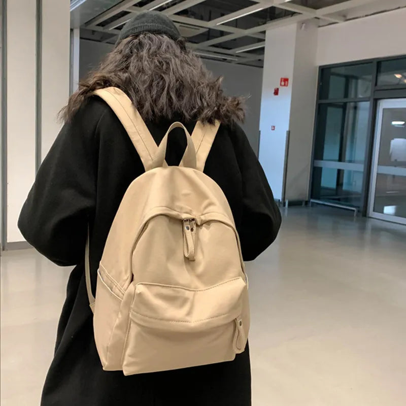 Cotton zip top backpack worn on the back