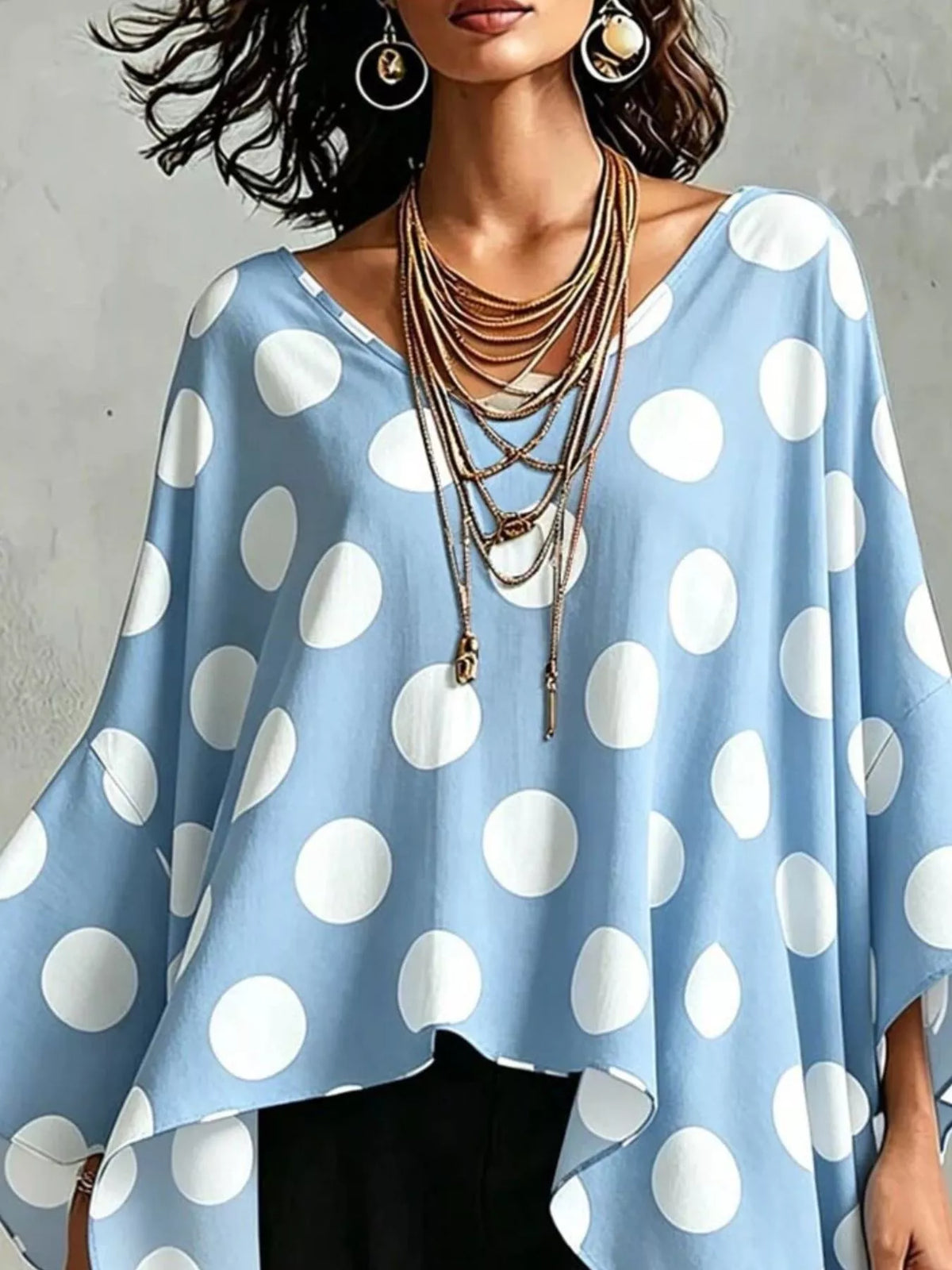Polka dot longline blouse shown in black