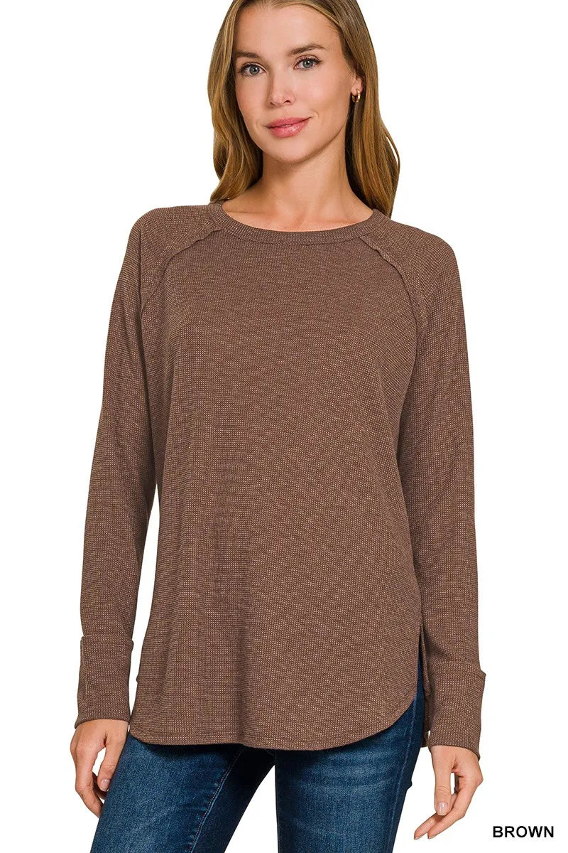Brown waffle knit top shown from the side with raglan sleeve