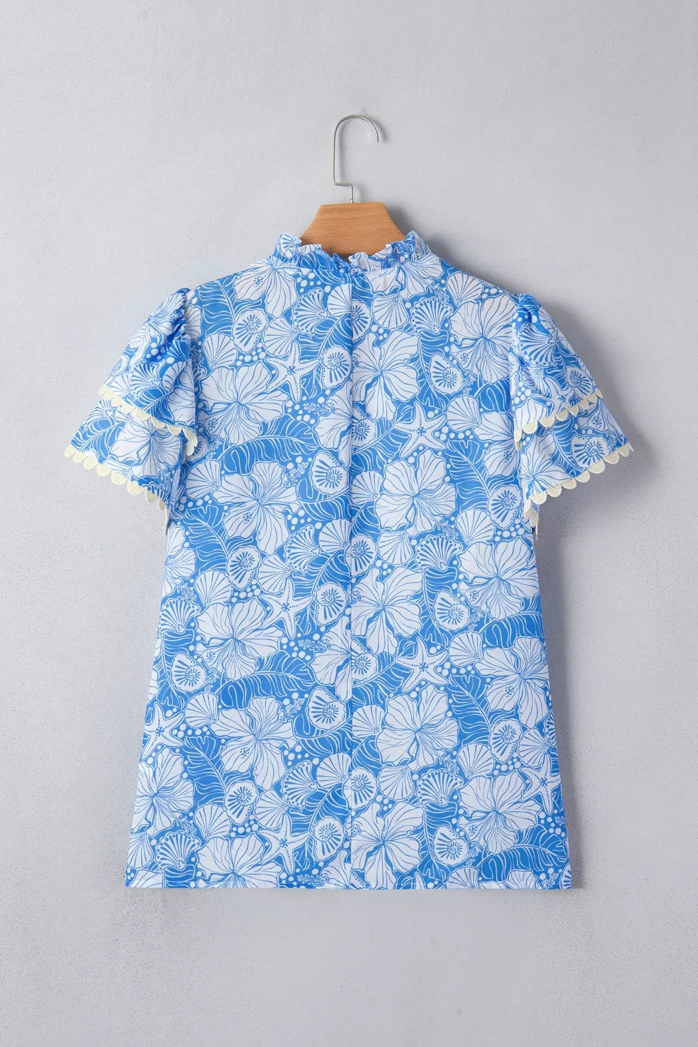 Light blue floral scalloped trim v neck blouse detail view