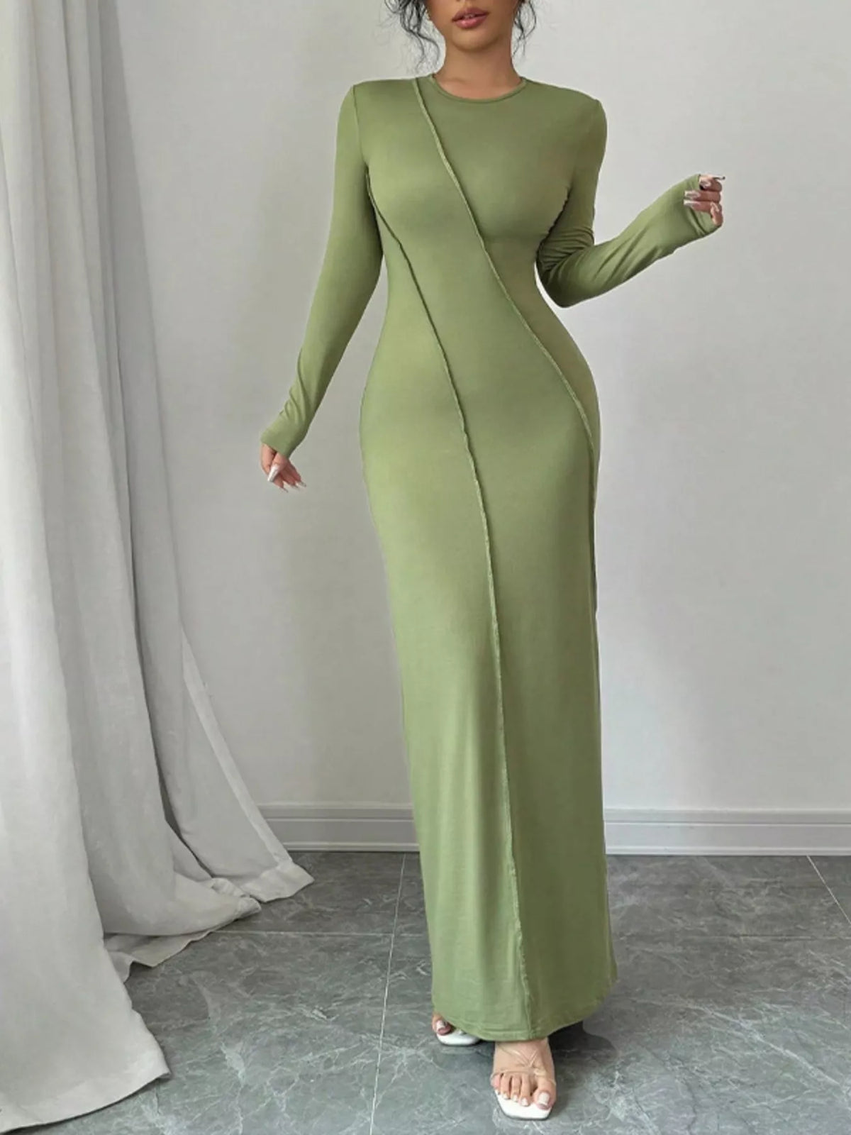 Green exposed seam long sleeve maxi dress three quarter view