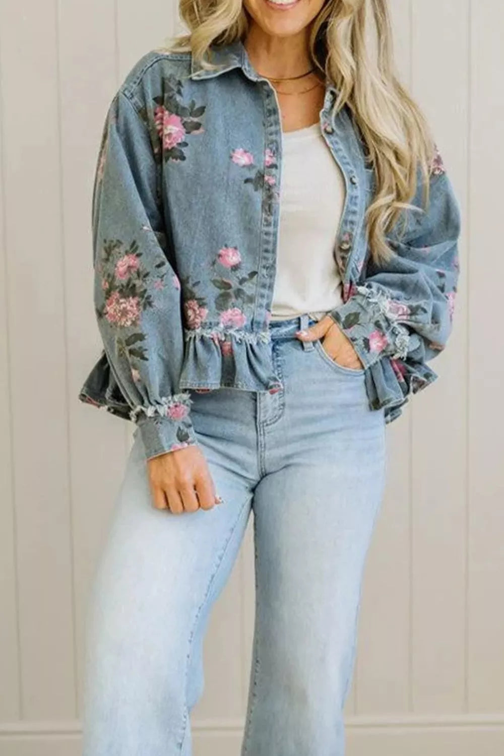 Denim jacket shown at a side angle over jeans