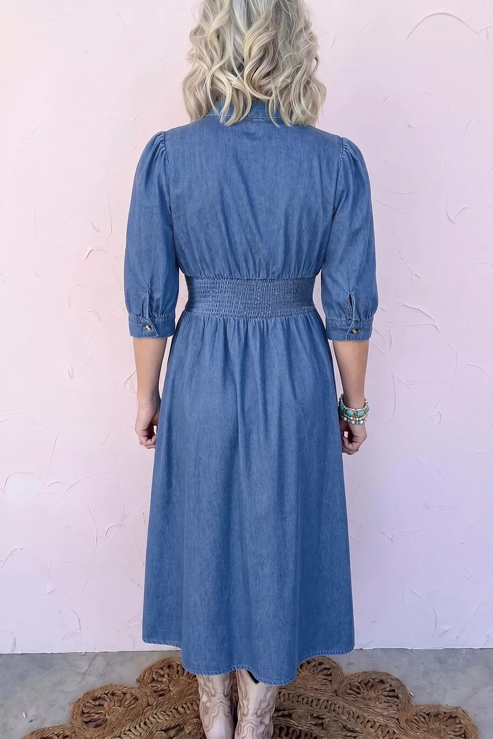 Denim midi dress side view showing shirred waist