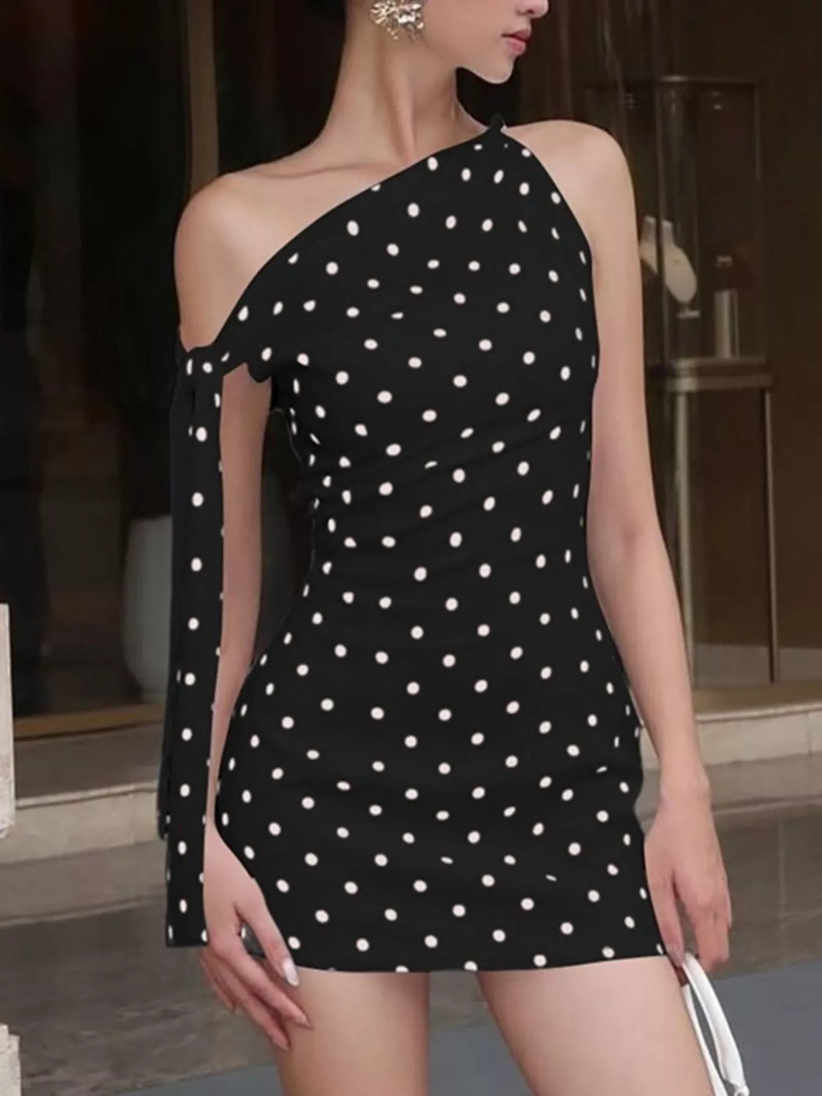 Asymmetrical split hem on the red polka dot mini dress