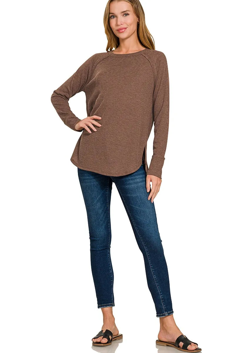 Close detail of the baby waffle knit texture and curved hem