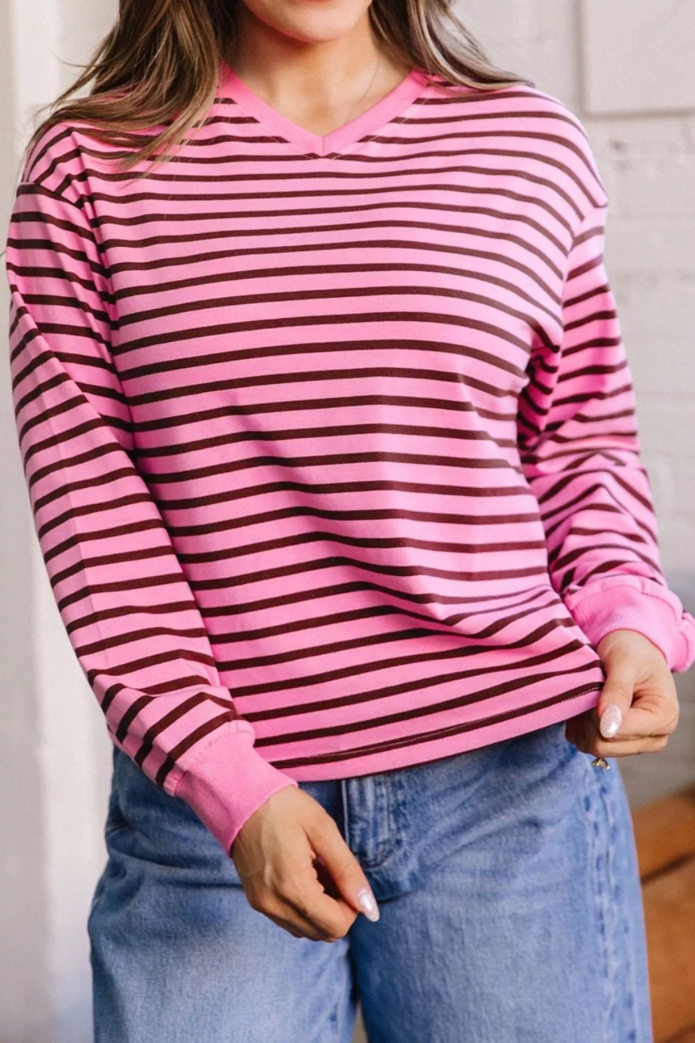 Striped v neck long sleeve top in fuchsia pink, full front view