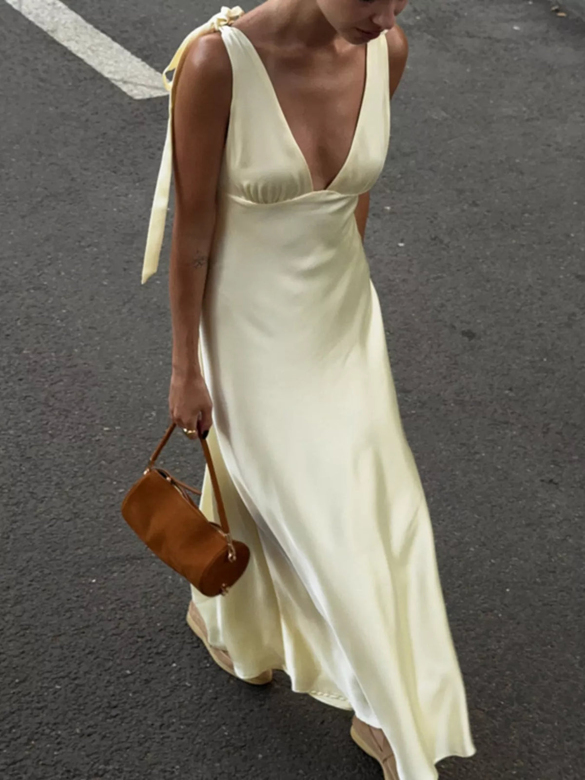 Deep V neckline detail on the beige satin dress