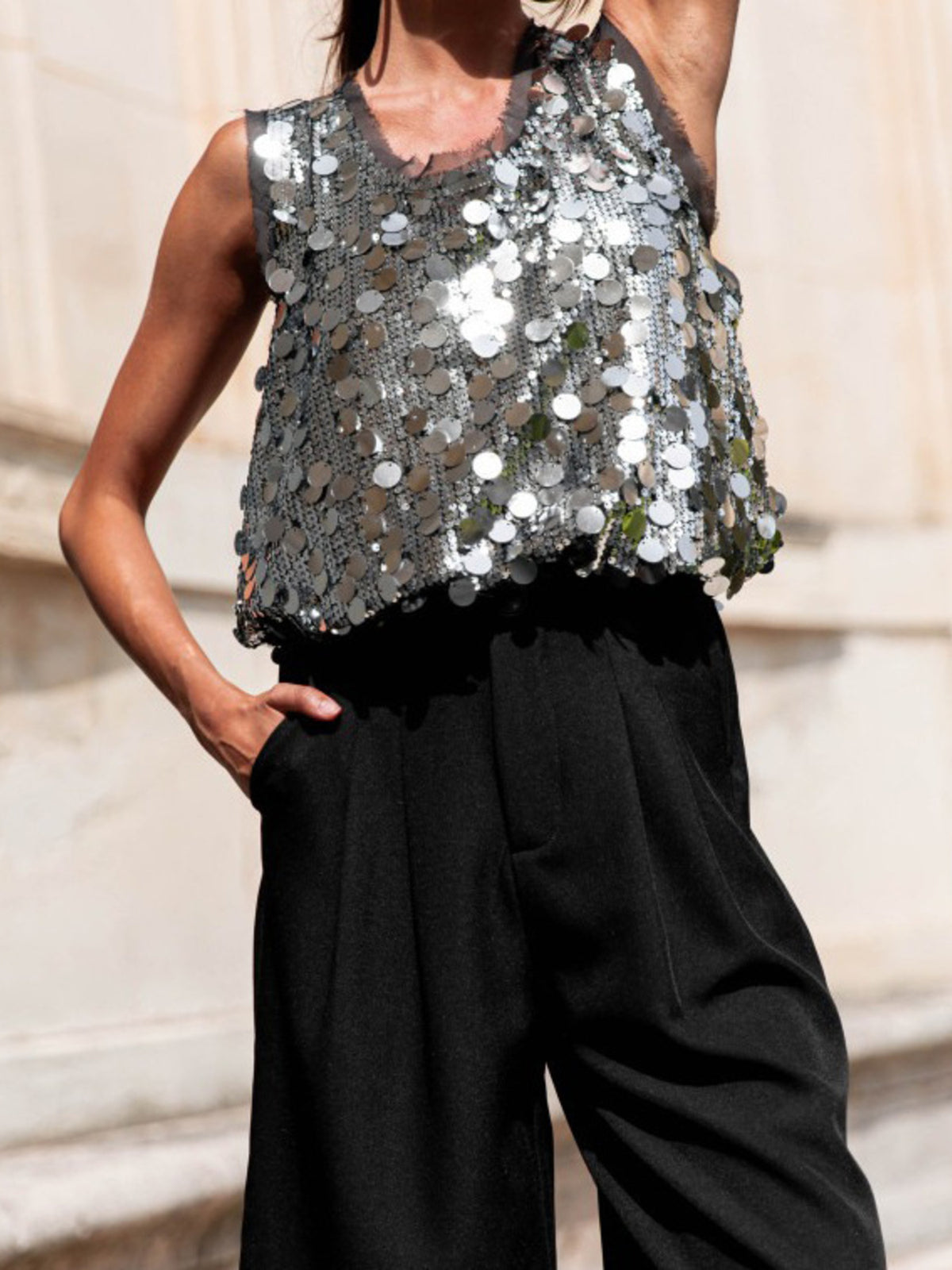 Model standing in the sequin round neck tank
