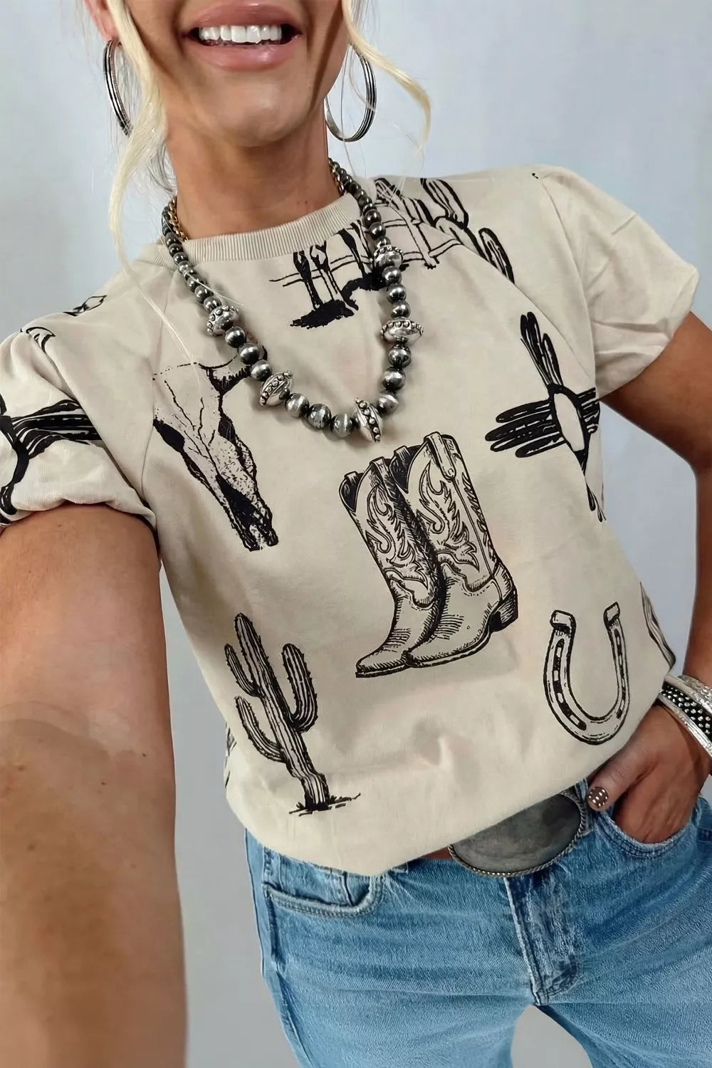 Close up of the western print on a khaki tee