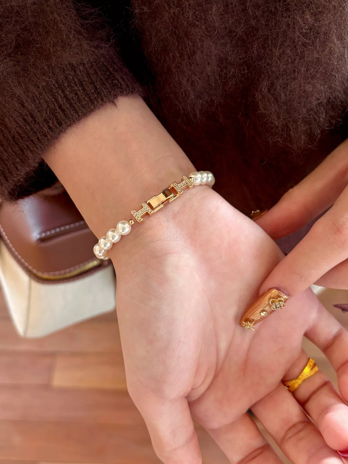 Pearl double H buckle bracelet on wrist