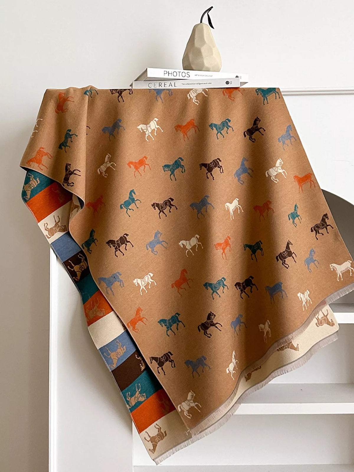Horse print scarf folded to show fabric texture