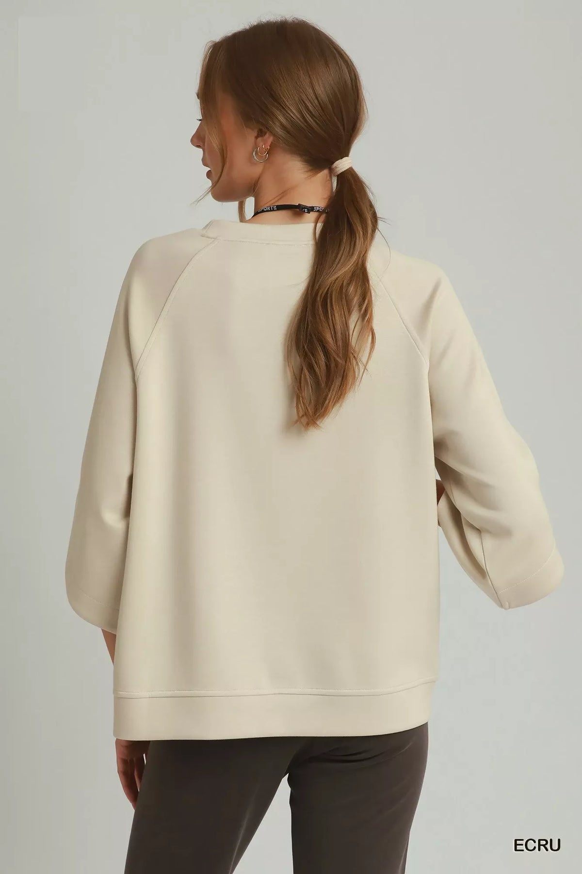 Raglan sleeve detail on ecru top