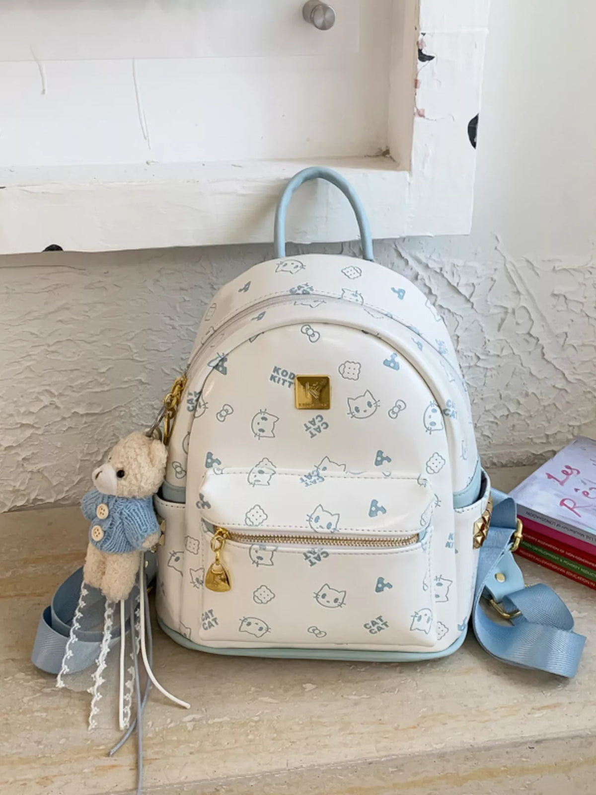 Mini backpack showing bear pendant charm