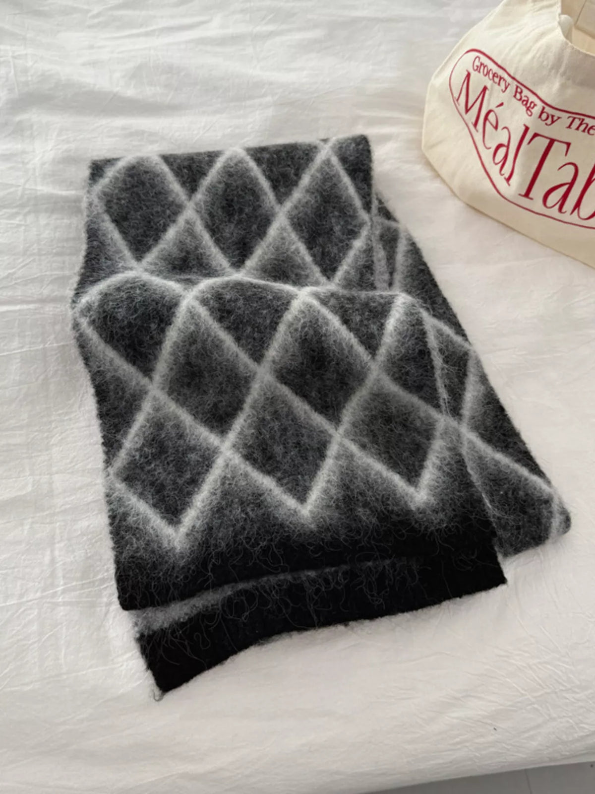 Diamond pattern fuzzy knit scarf draped side view