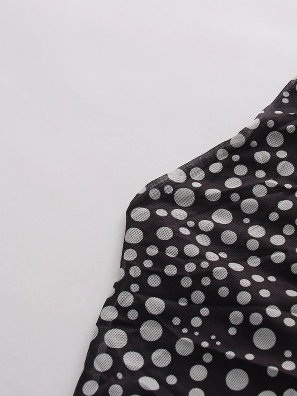 Black halter neck polka dot maxi dress, hemline detail