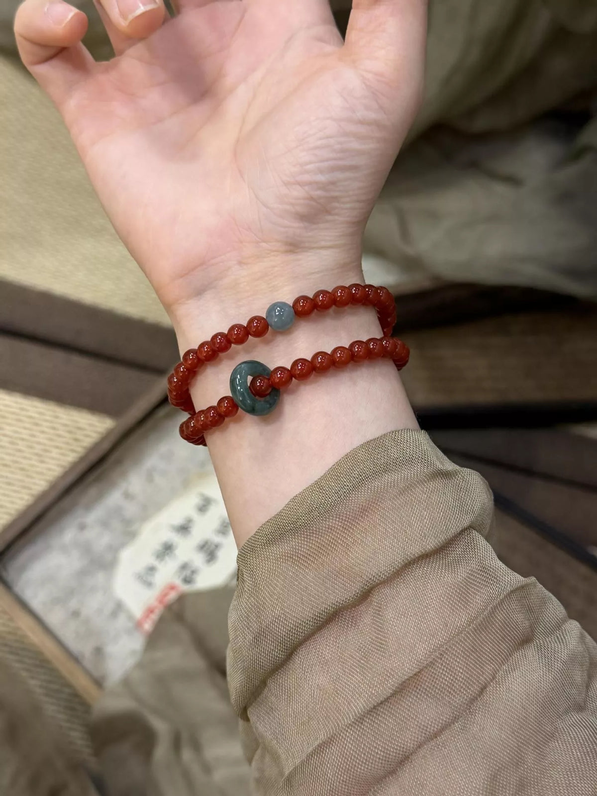 Deep red agate beaded bracelet detail view