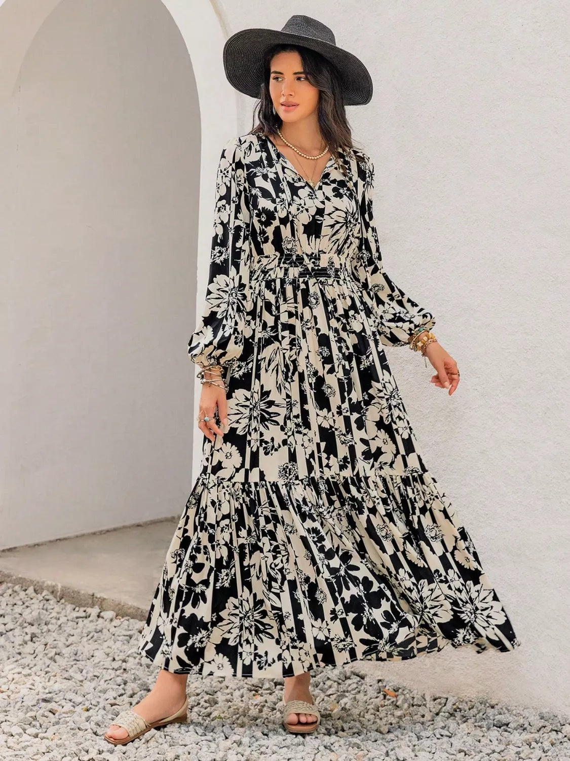 Plus size floral balloon sleeve maxi dress in black detail of the hem