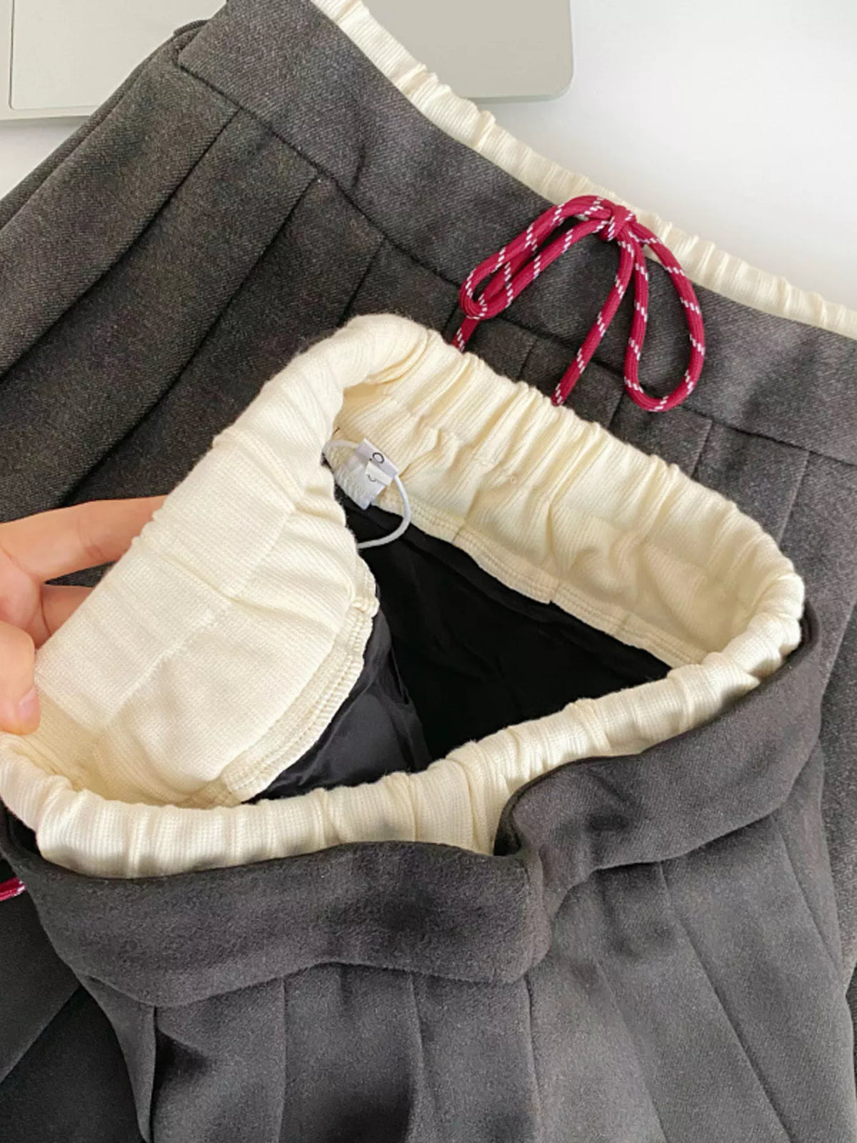 Gray pleated skirt on model