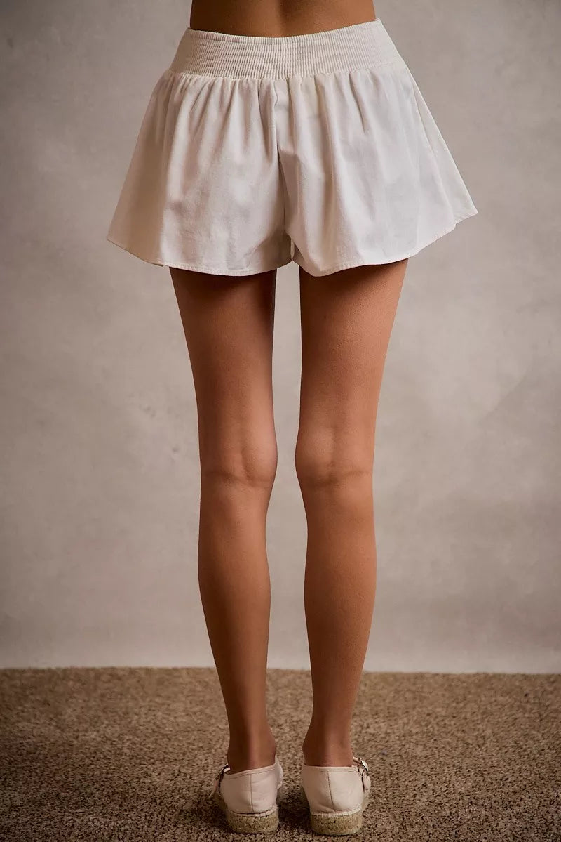 White denim bubble skort with smocked back waist side view