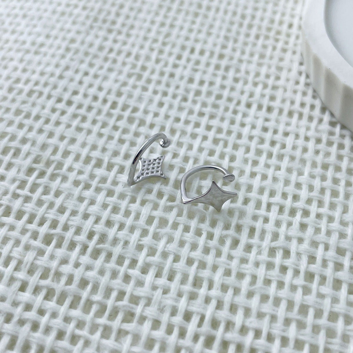 Sterling silver star cuff earrings shown as a pair