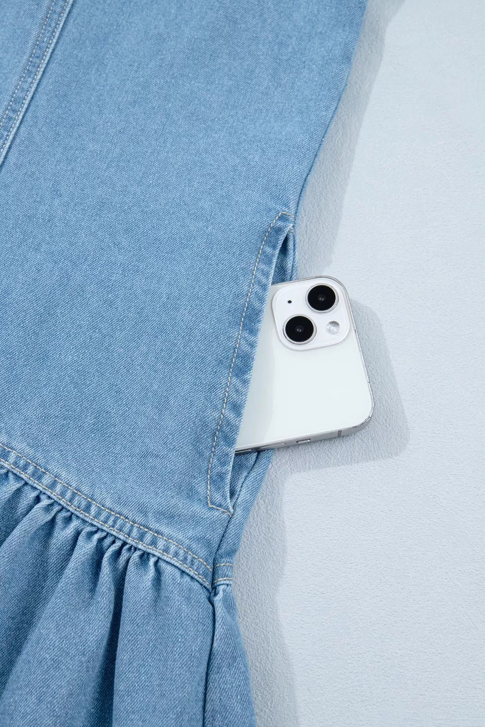 light wash puff sleeve ruffle hem denim dress hem detail