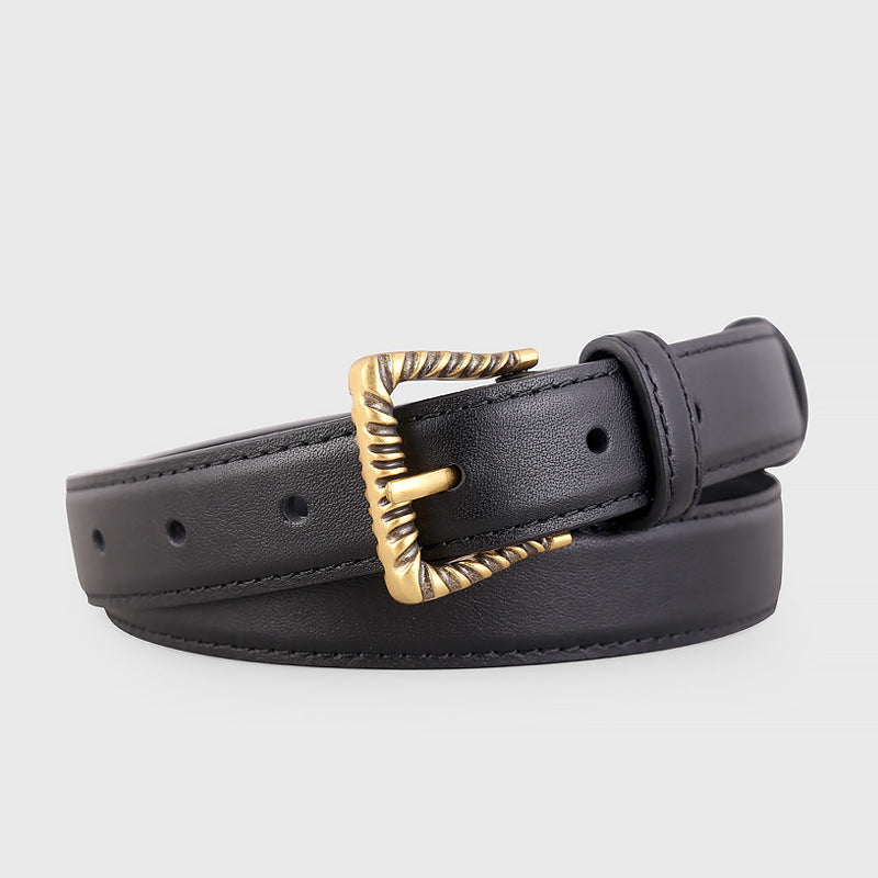 Leather belt with textured gold buckle coiled
