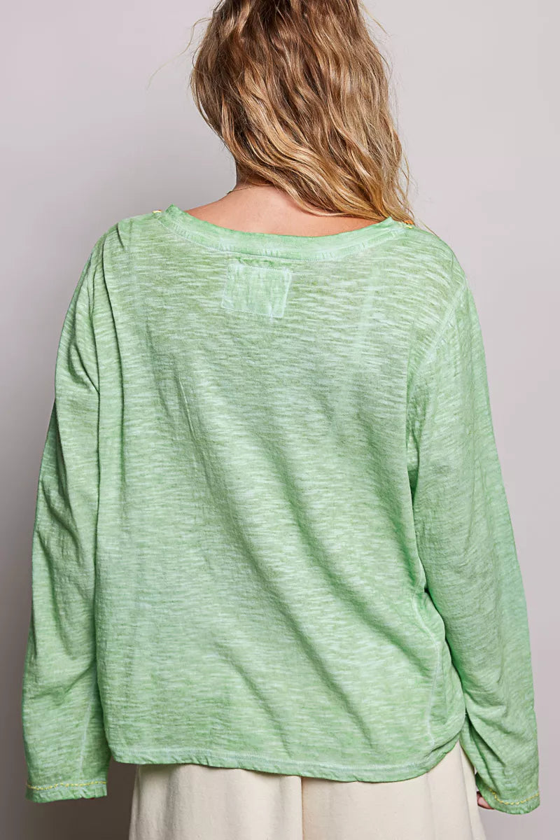Close up of the contrast hand stitch accents on the v neckline