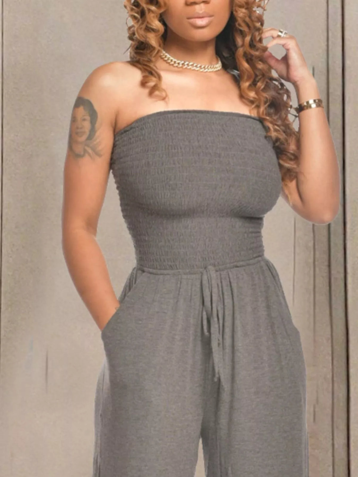 Grey strapless smocked wide leg jumpsuit front detail