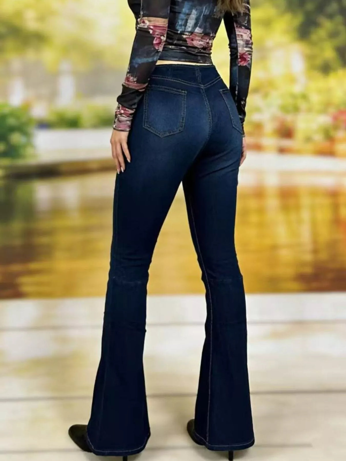 High rise flare denim standing pose