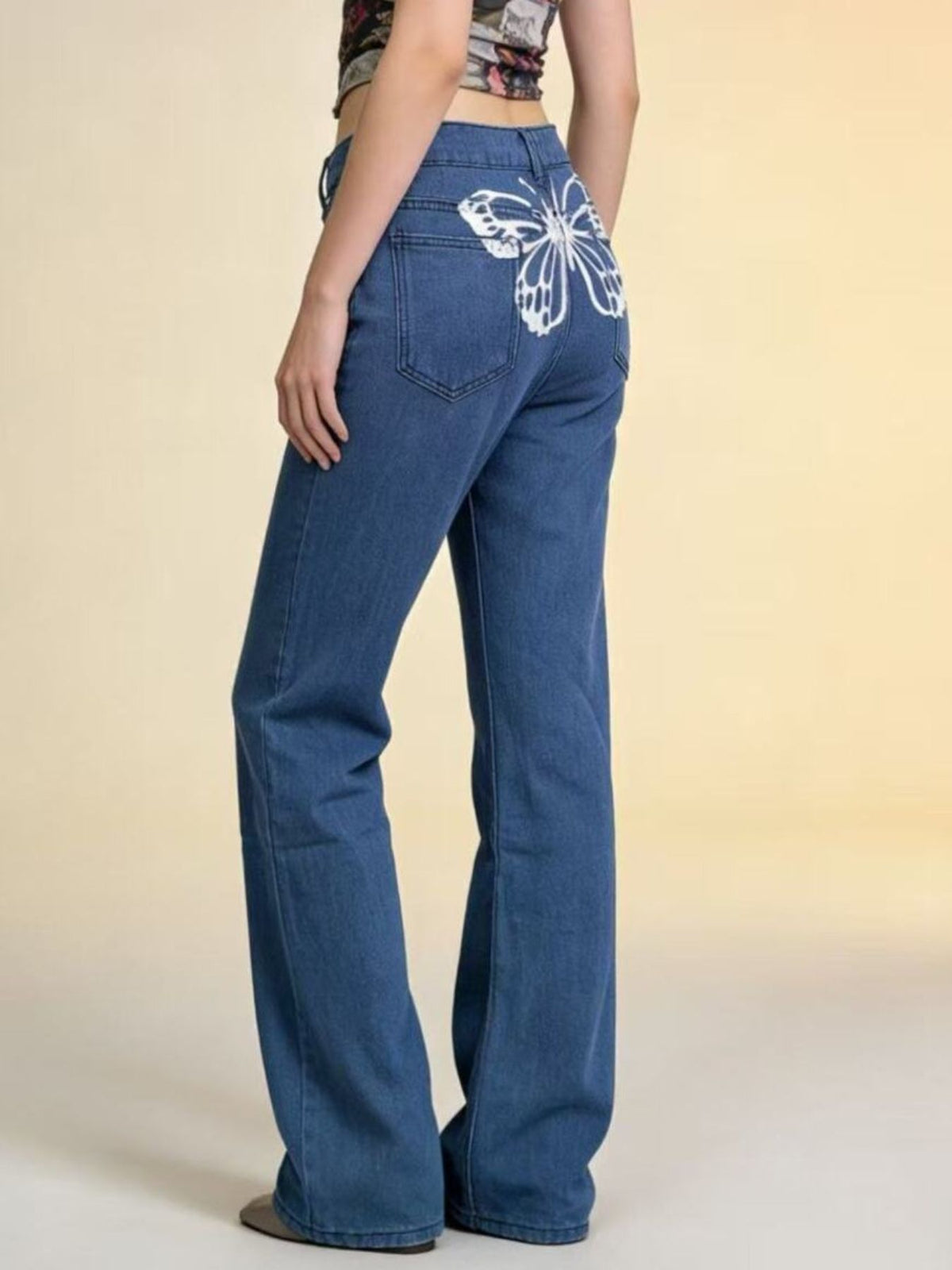 Back view highlighting butterfly detailing on jeans