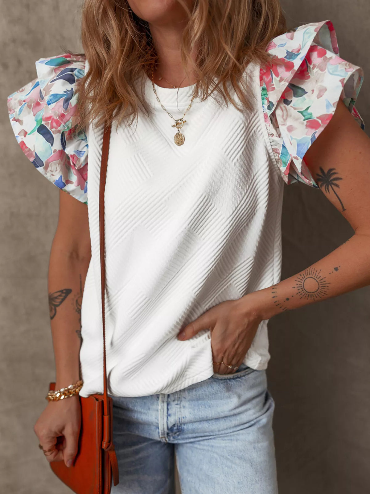 White abstract print tiered ruffle sleeve top detail view