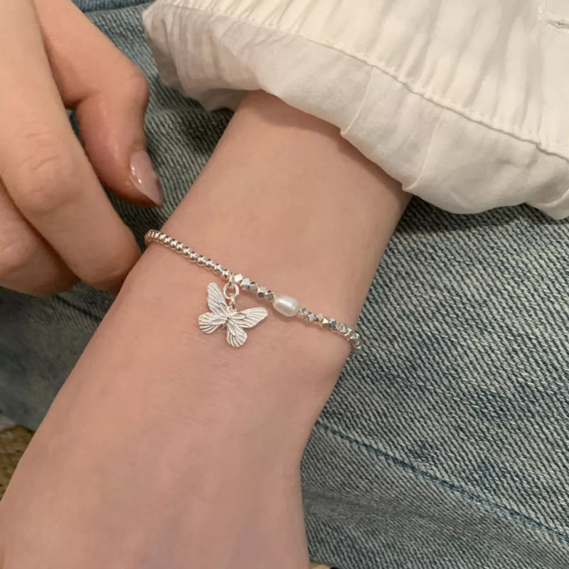Sterling silver butterfly bracelet laid flat to show the full chain