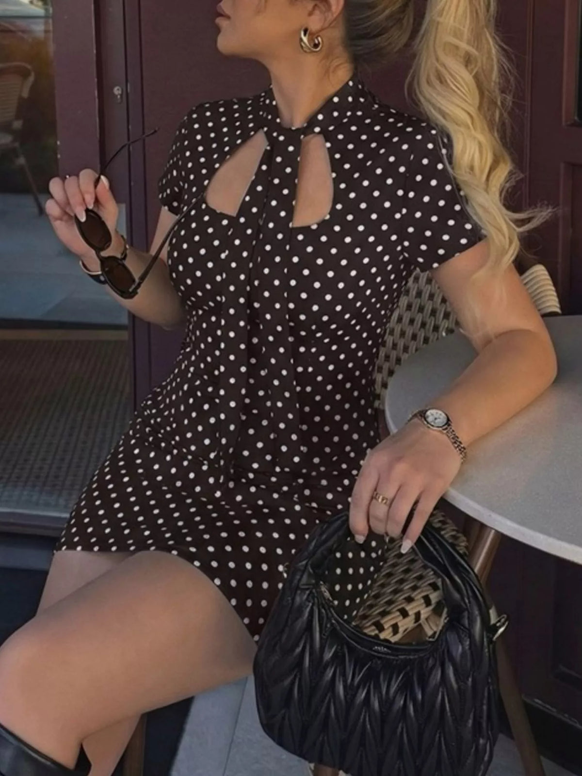 White polka dot dress styled with flat sandals