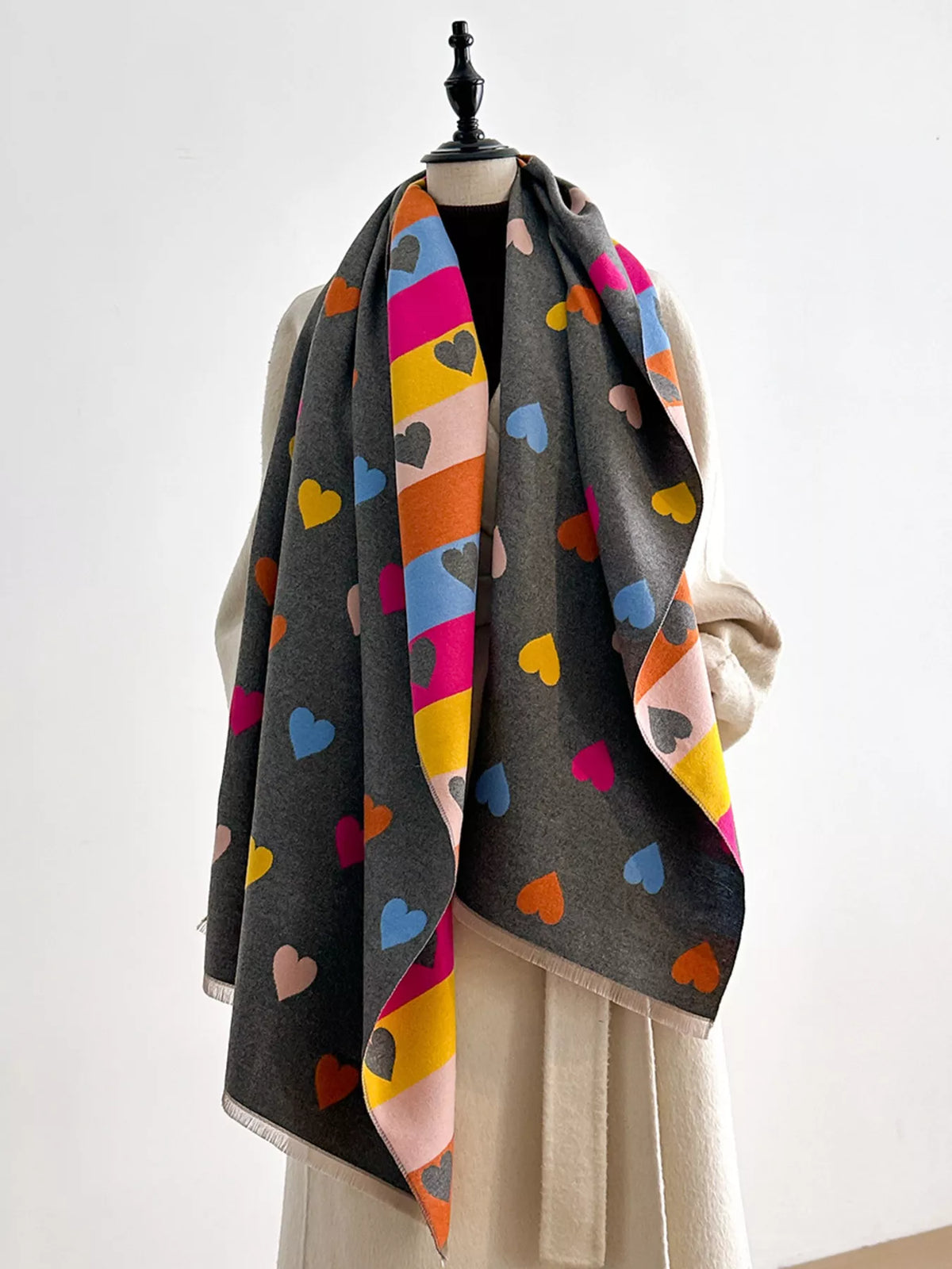 Heart print scarf styled over a coat