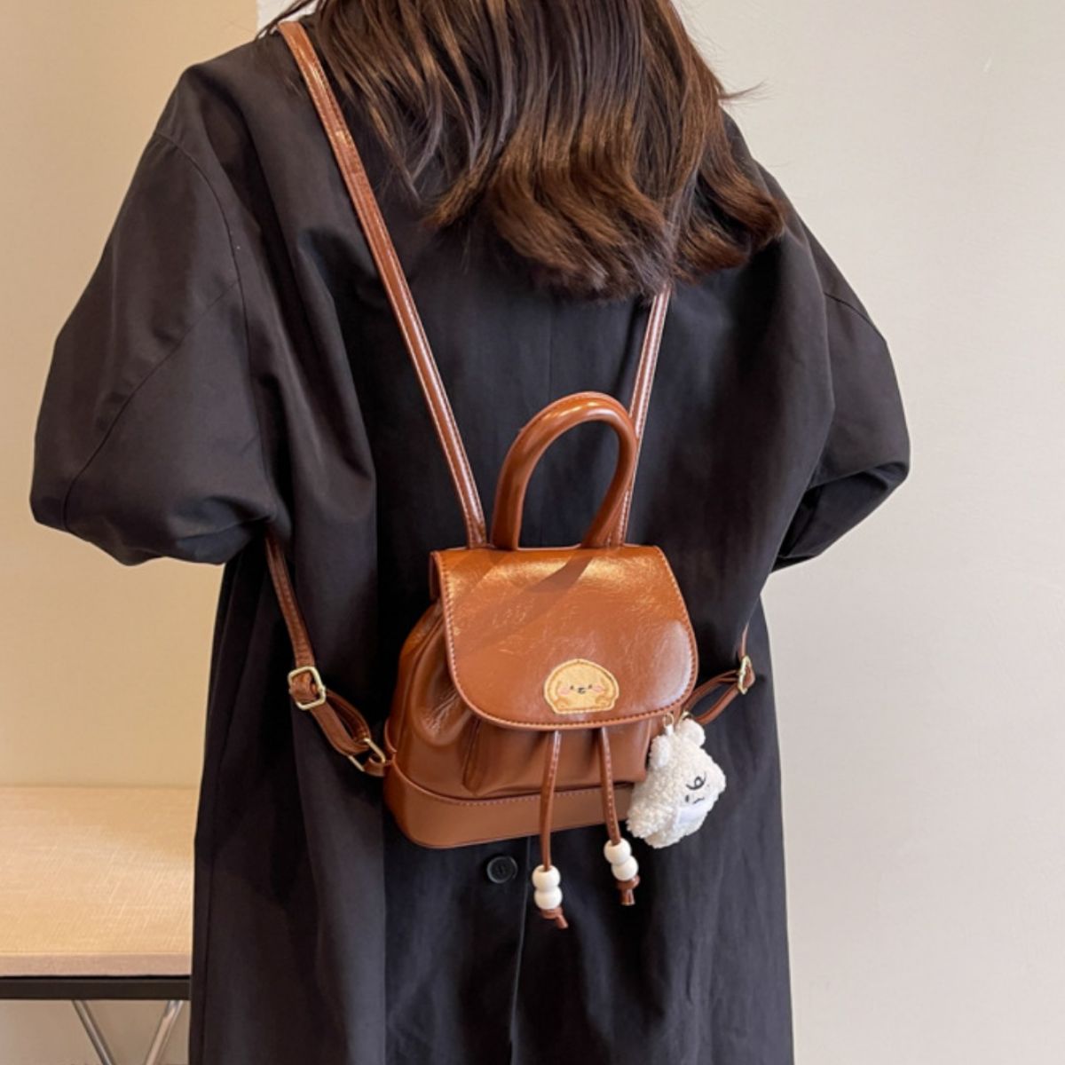 brown puppy patch mini backpack top handle and zip detail