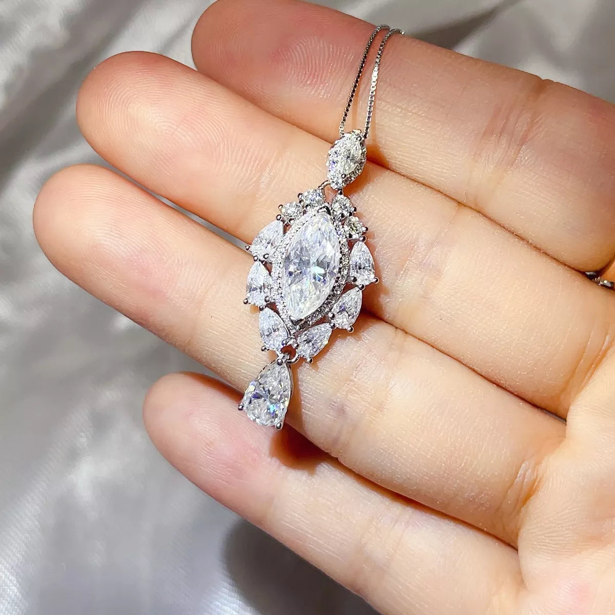 Moissanite pendant worn at the collarbone