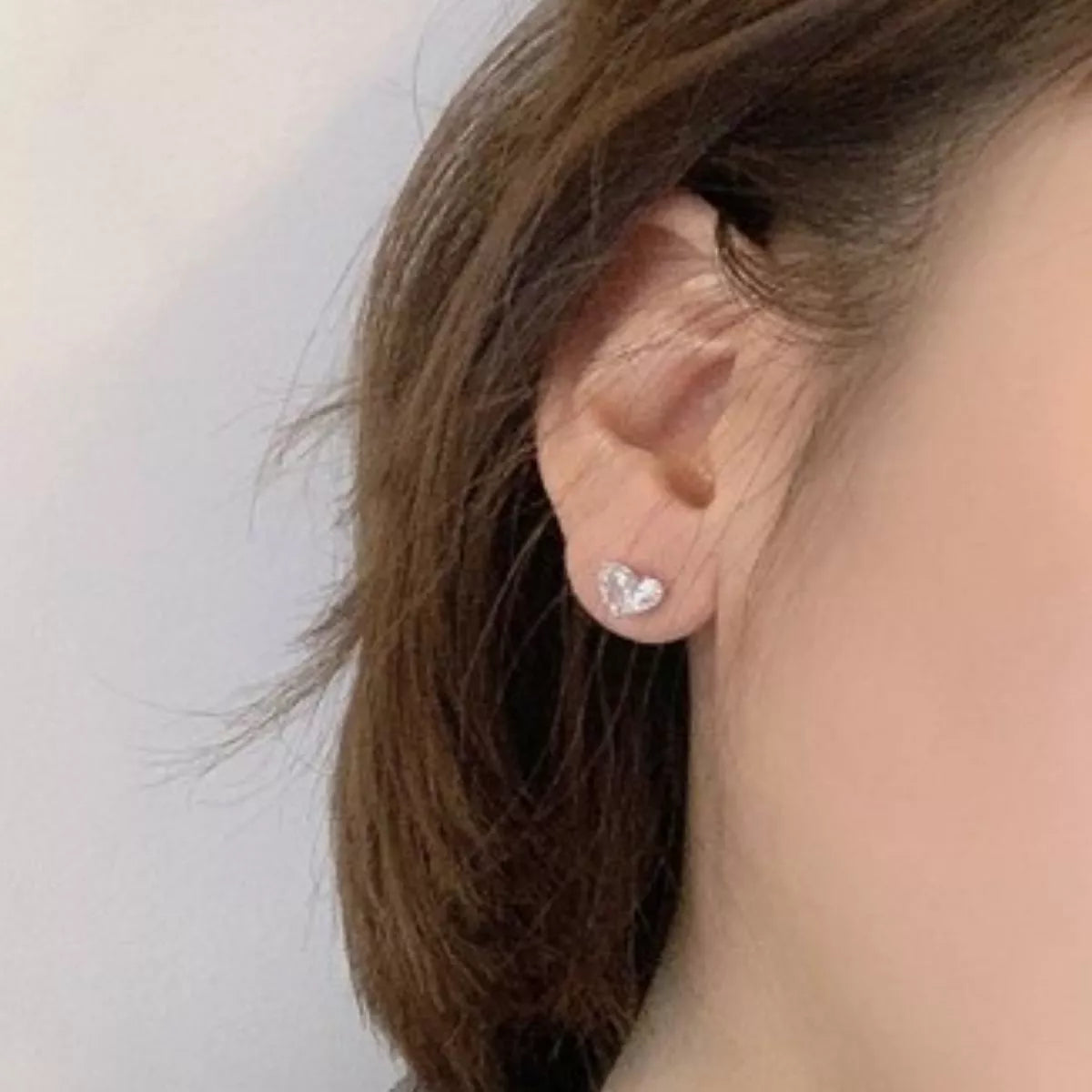 Heart cut moissanite earrings shown as a pair